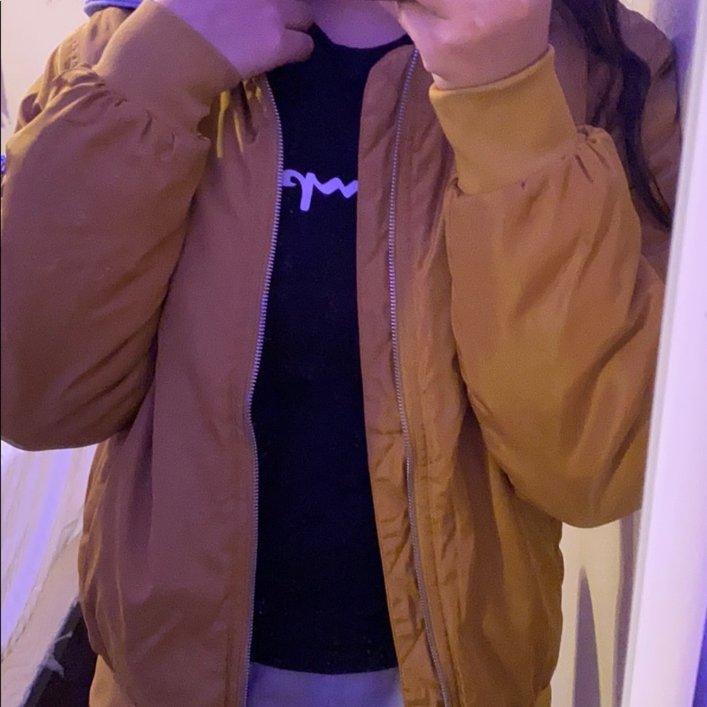 A light brown hooded bomber jacket